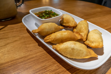Chinese dumplings on plate with dipping sauce