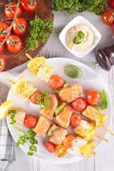 fish salmon and tomato barbecue - skewer on wooden board