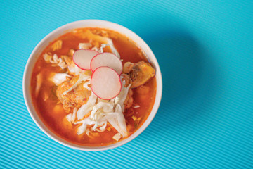 Delicious typical Mexican red Mexican pozole with tostadas