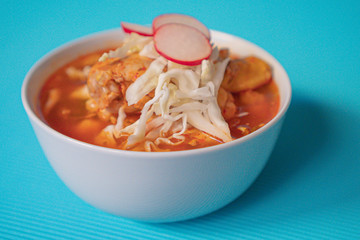 Delicious typical Mexican red Mexican pozole with tostadas