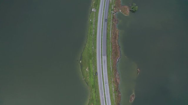 Aerial view of rural road through abandoned tin mine ponds in Kampar, Perak, Malaysia