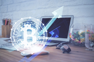 Multi exposure of blockchain and crypto economy theme hologram and table with computer background. Concept of bitcoin cryptocurrency.