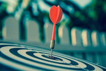 The bullseye, or bull's-eye or dart board has dart arrow hitting the center of a shooting target...