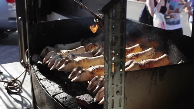 Burning pork pig legs with a flame thrower