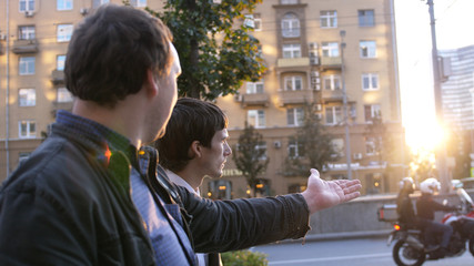 Businessmen walking and talking on street discussing work outdoor, tracking shot.