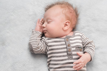 cute baby in a striped suit cute sleeps