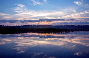 Beautiful autumn landscape sunset over a quiet forest lake