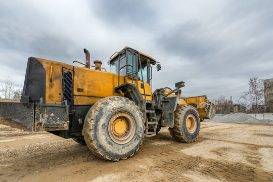 Wheel loader rides on a construction site.