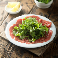Beef carpaccio with arugula salad