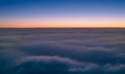 Fototapeta na wymiar Flying above the clouds at sunrise