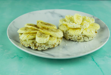 Wheat slices with coconut paste, bananas and cinnamon with peanuts
