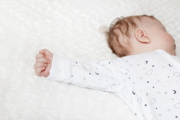 cute baby sleeps in pajamas. baby hand