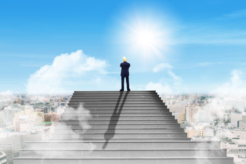 Business Success Concept : Miniature as businessman standing on the top of concrete staircase and looking forward to cityscape.