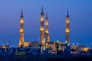 Sheikh's Zayed's Mosque glowing colors in Ras al Khaimah, UAE at night echos prayer call along the ...