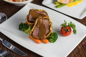 Baked pork with broccoli and tomato