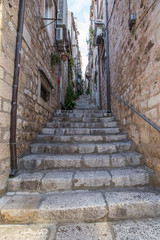 Fototapeta na wymiar Narrow street with stone stairs in Dubrovnik old city center