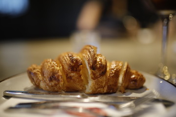 sliced Croissant on white dish in coffee shop