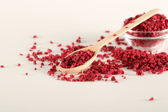 raspberries dry crushed freeze dried on a white background