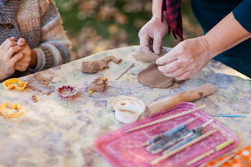 children make clay figures by pottery