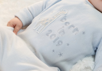 a child dressed in a bodik born in 2019