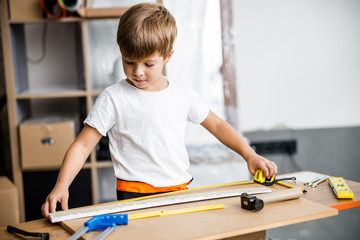 Cheerful boy with tape measure stock photo