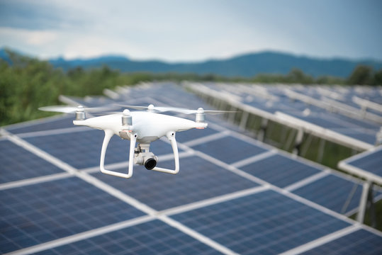Drones and solar cells, The drone is a high angle camera shooting a solar cell farm. Which is clean energy Able to generate electricity