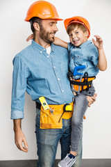 Cheerful parent with kid during flat repairing stock photo