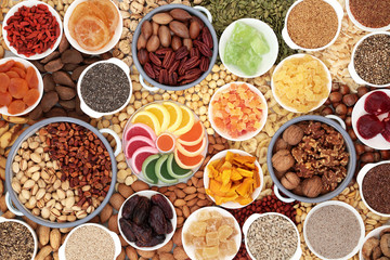 Dried fruit nuts and seed collection forming a background. Health food high in antioxidants, protein, omega 3, minerals, vitamins and anthocyanins. Flat lay.