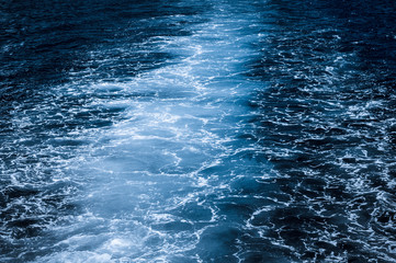 Dark blue ocean with white spray / Nature background, dark blue ocean with white spray.