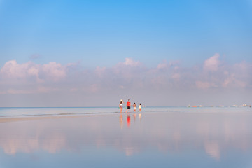 Couples enjoying the early morning walk at the shore of Boracay, Philippines