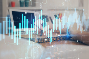 Financial graph displayed on woman's hand taking notes background. Concept of research. Double exposure