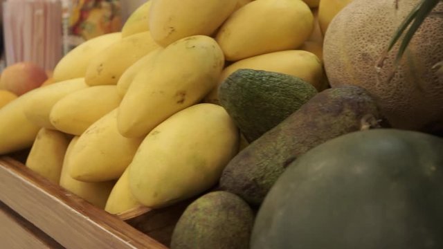Track shot from right to left of a fresh fruit ingredients for smoothie selling in the market