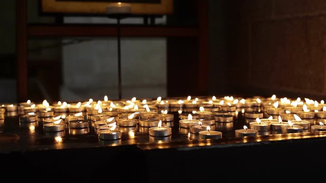 Many candles in church, medium shot
