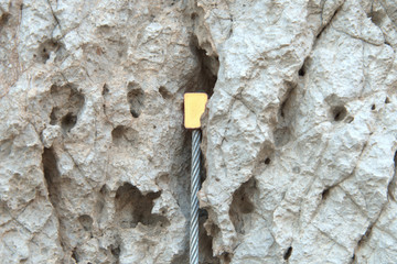 Rock climbing nut placed on crack 