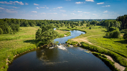 Fototapeta na wymiar Field and river Usherka near Sudogda in summer, shooting from a quadcopter. Russia, Vladimir region