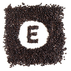 Letter E made out of aromatic coffee beans, top view, isolated on white background. Letter from word Coffee.