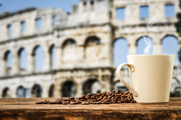 Black coffee on a wooden table in the center of Rome and free space for an advertising product
