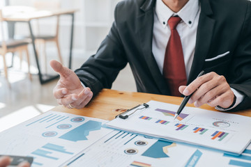 Group of business people meeting together to assess business profits.