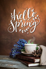 Vintage photo of books, coffee cup and lavander with text Hello Spring