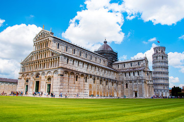 Picturesque landscape with San Giovanni Baptistery, part of cathedral or Duomo di Santa Maria Assunta near famous Leaning Tower in Pisa, Italy. fascinating exotic amazing places. Piazza dei Miracoli.