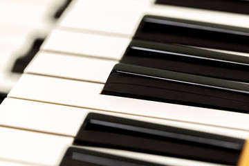 Pipe organ double keyboard macro. Black and white keys extreme closeup, shallow depth of field, detail shot. Stylish musical background texture, classical music abstract. Focus on single key, nobody