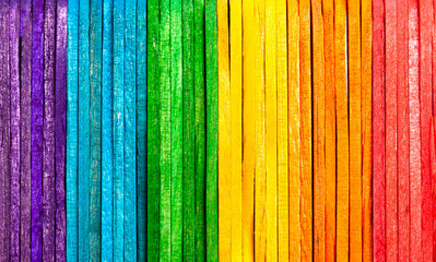 Simple colorful natural full rainbow made from wooden popsicle sticks, eco background texture...