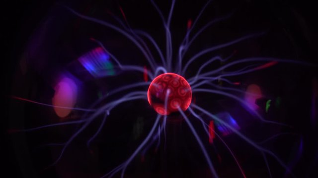Closeup view 4k video of magic plasma ball glowing in darkness. 