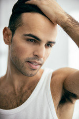 Happy young man in white t-shirt with stylish hair