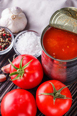 juicy canned tomatoes on wooden rustic background