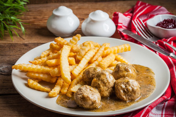 Meatballs with french fries in dill sauce.