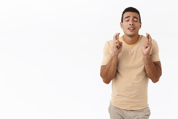 Hopeful and pumped handsome young male sportsman want get accepted team, close eyes and praying,...