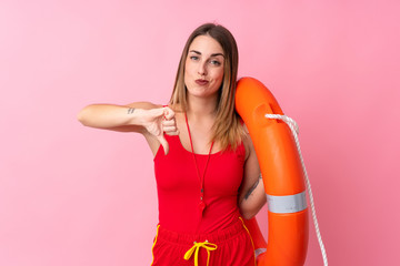Lifeguard woman over isolated background showing thumb down sign