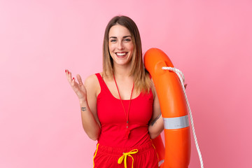 Lifeguard woman over isolated background laughing