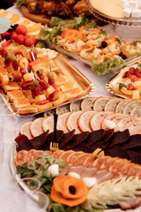 Beautifully served table in a restaurant. The served holiday table with russian snacks. Buffet table of reception with cold snacks, meat, salad